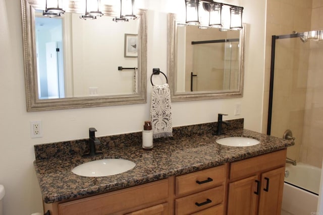 bathroom with vanity and combined bath / shower with glass door