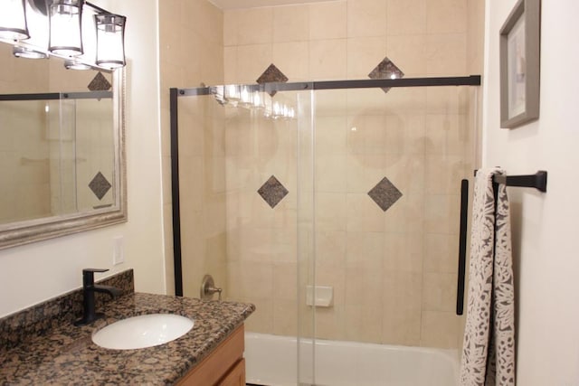 bathroom with vanity and bath / shower combo with glass door