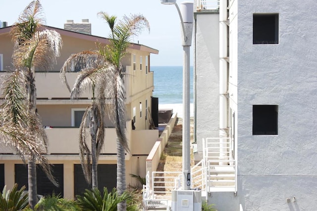 1365 Seacoast Dr Unit E, Imperial Beach, CA 91932 - view of building exterior with stairway, a water view, and a garage