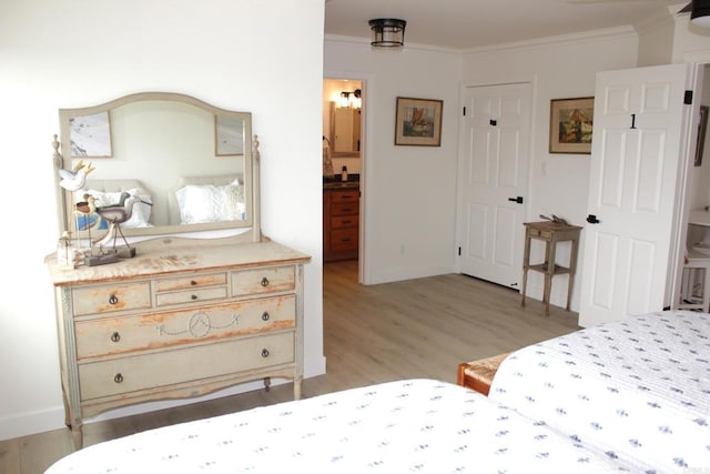 1365 Seacoast Dr Unit E, Imperial Beach, CA 91932 - bedroom featuring light wood-style floors, ornamental molding, baseboards, and ensuite bath