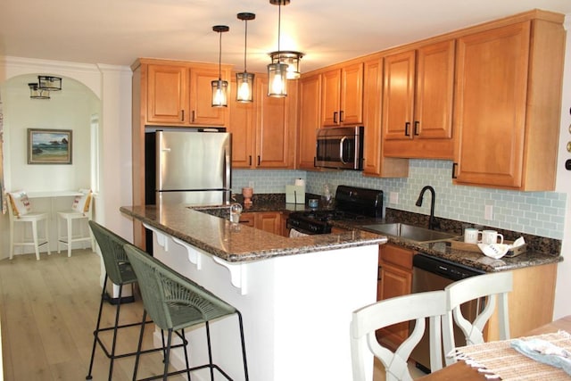 1365 Seacoast Dr Unit E, Imperial Beach, CA 91932 - kitchen featuring appliances with stainless steel finishes, a sink, arched walkways, and backsplash