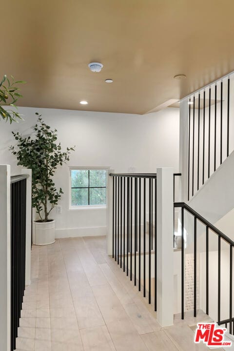 corridor featuring light tile patterned floors