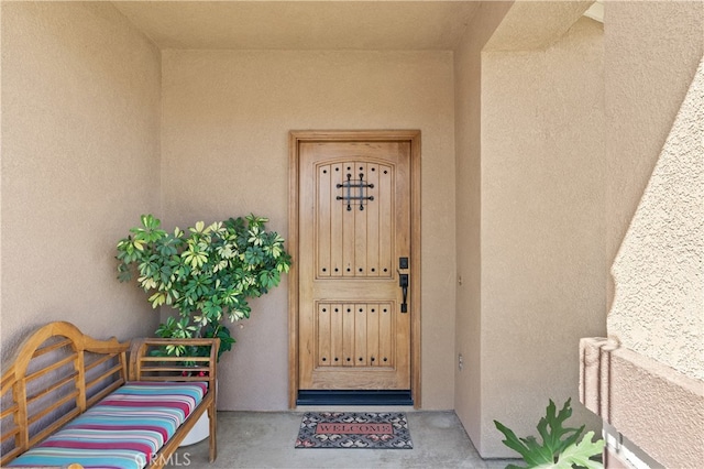 doorway to property with stucco siding