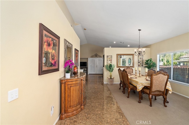 dining area featuring lofted ceiling, a notable chandelier, and baseboards