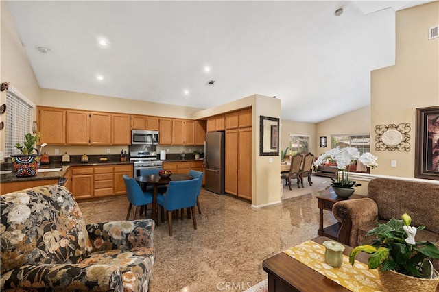 kitchen featuring recessed lighting, dark countertops, visible vents, appliances with stainless steel finishes, and brown cabinetry