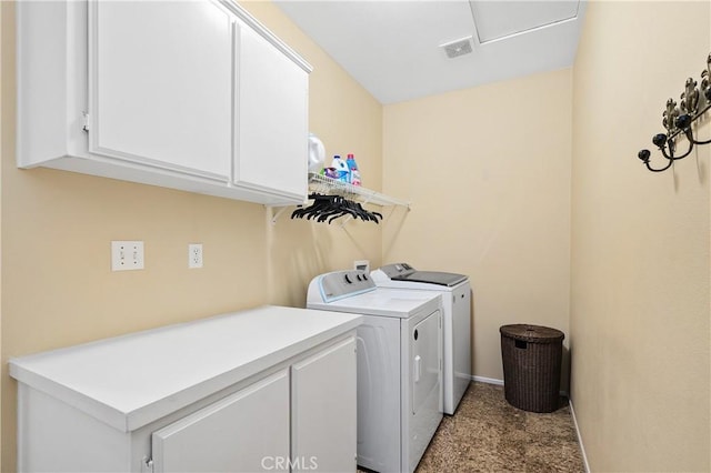 washroom featuring visible vents, washer and clothes dryer, cabinet space, and baseboards