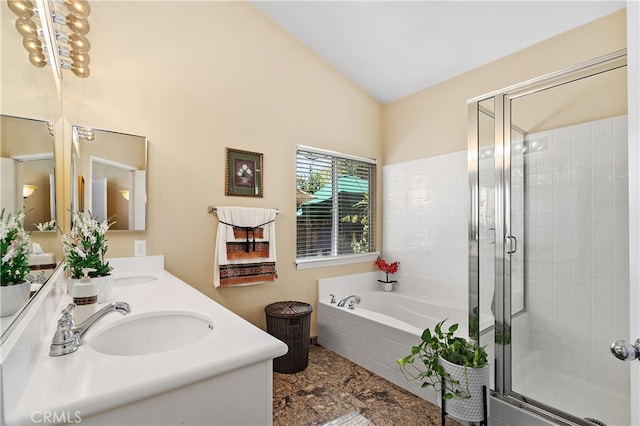 full bathroom with a garden tub, a sink, vaulted ceiling, double vanity, and a stall shower