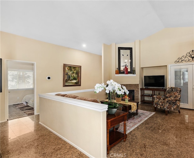 living area with vaulted ceiling, a lit fireplace, recessed lighting, and baseboards