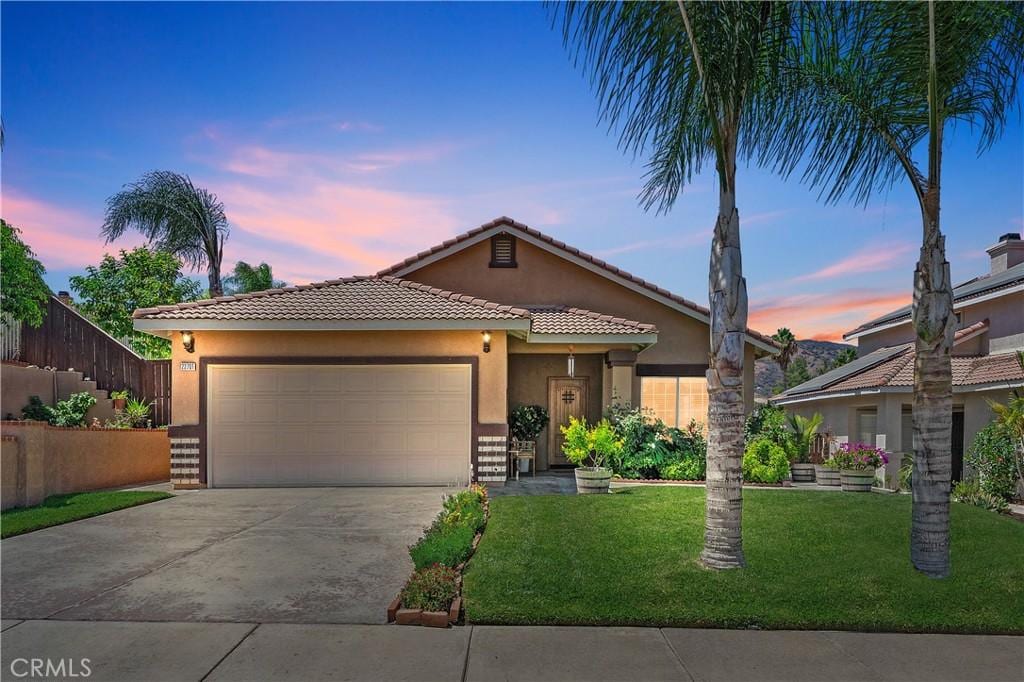 22701 Hannah Ct, Corona, CA 92883 - view of front of home featuring a tiled roof, stucco siding, a garage, and concrete driveway