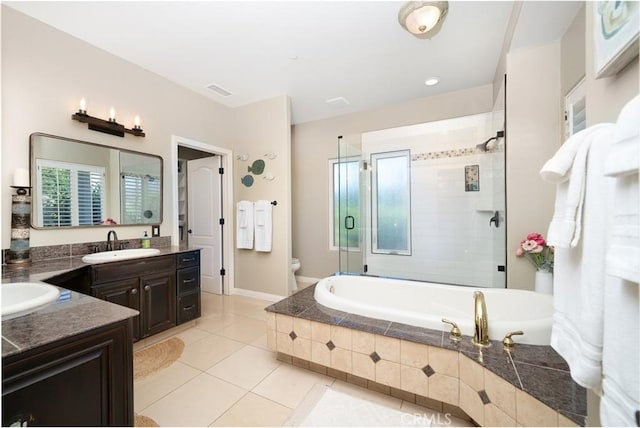 full bathroom with tile patterned floors, vanity, toilet, and plus walk in shower