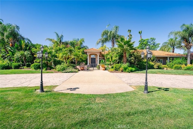 mediterranean / spanish-style home with a front yard