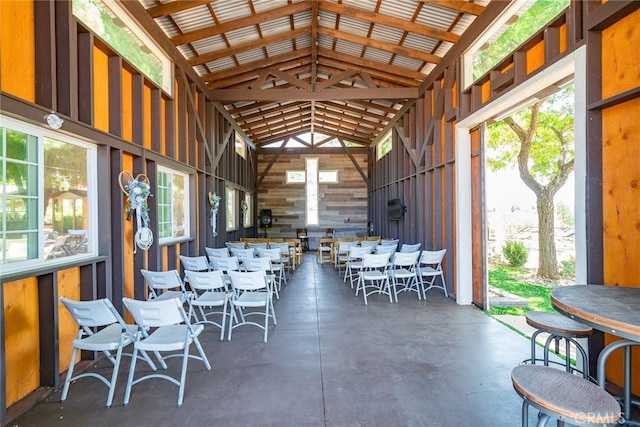 interior space with wood walls and high vaulted ceiling