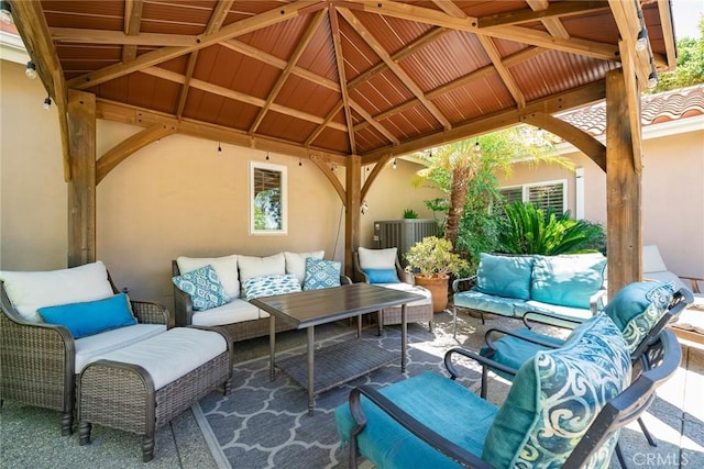 view of patio with a gazebo, outdoor lounge area, and central AC