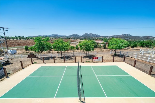 view of tennis court featuring a mountain view and basketball court