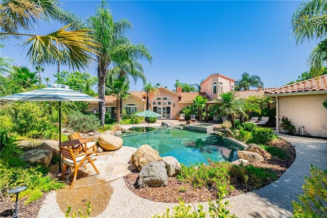 view of pool with an in ground hot tub and a patio