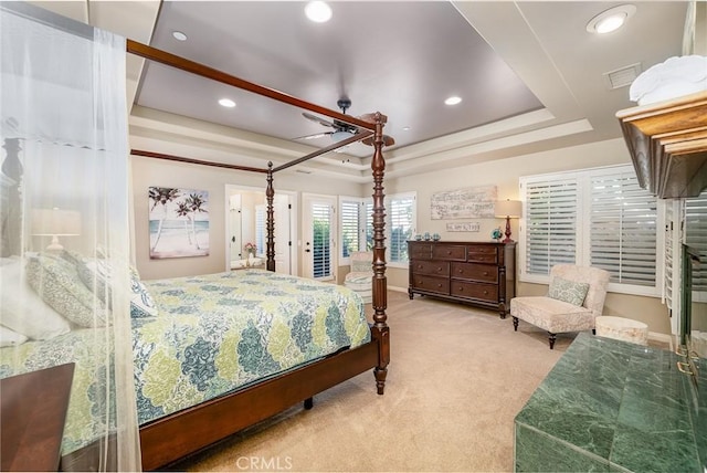 bedroom featuring a tray ceiling, ceiling fan, and carpet floors