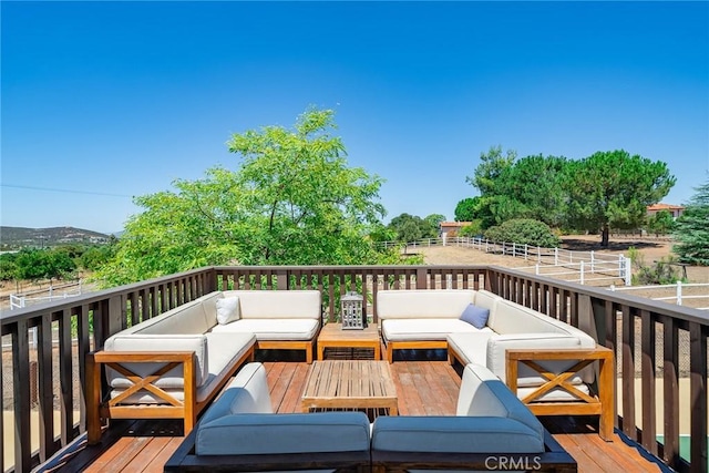 wooden terrace featuring an outdoor living space