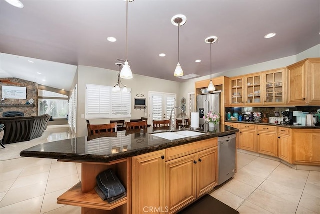 kitchen featuring plenty of natural light, a kitchen island with sink, sink, and appliances with stainless steel finishes