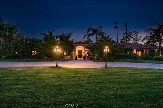 mediterranean / spanish-style house with a front yard