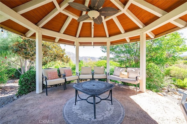 view of patio / terrace featuring a gazebo, outdoor lounge area, ceiling fan, and a mountain view