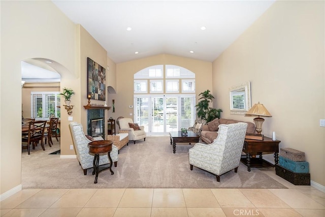 living area featuring light tile patterned floors and high vaulted ceiling