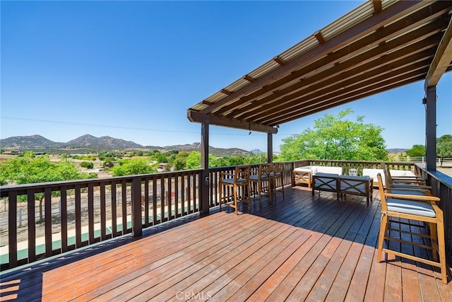 wooden deck with a mountain view and an outdoor hangout area