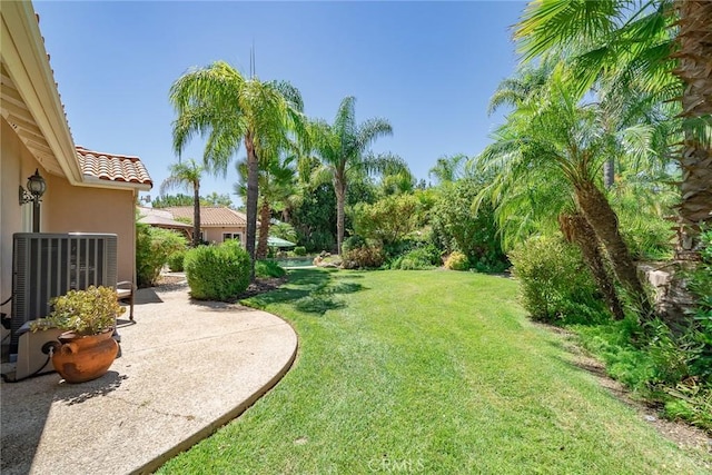 view of yard with a patio and central AC unit