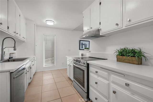 kitchen featuring light tile patterned floors, stainless steel appliances, sink, and white cabinets