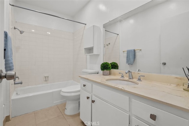 full bathroom with toilet, tiled shower / bath combo, vanity, and tile patterned flooring