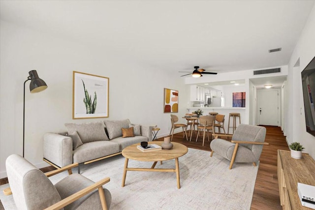 living room with hardwood / wood-style flooring and ceiling fan