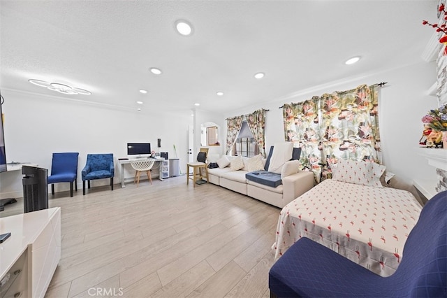 living room with light wood-type flooring and ornamental molding