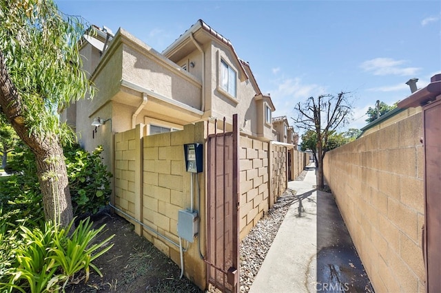 view of side of property featuring fence