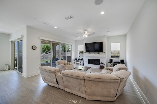 living room featuring ceiling fan and hardwood / wood-style flooring