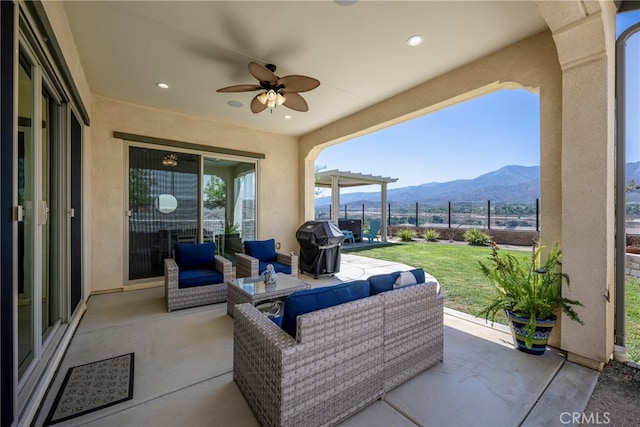 view of patio / terrace featuring ceiling fan, a mountain view, grilling area, and outdoor lounge area