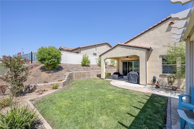 view of yard featuring a patio and ceiling fan