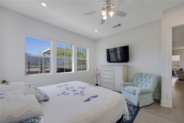 bedroom with wood-type flooring and ceiling fan