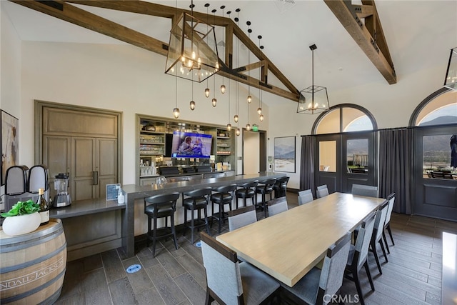 dining room featuring a notable chandelier, beam ceiling, dark hardwood / wood-style floors, and high vaulted ceiling