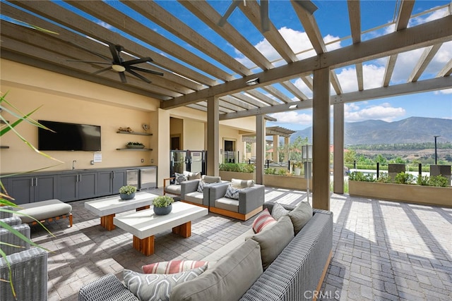 view of patio / terrace featuring a pergola, a mountain view, ceiling fan, and outdoor lounge area