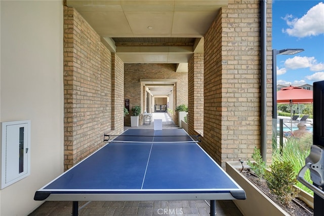 game room with brick wall