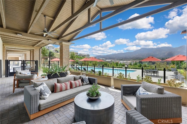 view of patio / terrace with outdoor lounge area, a mountain view, and ceiling fan