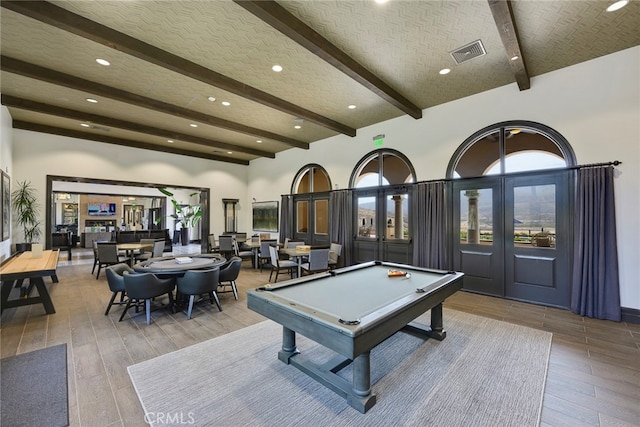 game room featuring light hardwood / wood-style floors, billiards, beamed ceiling, a high ceiling, and french doors