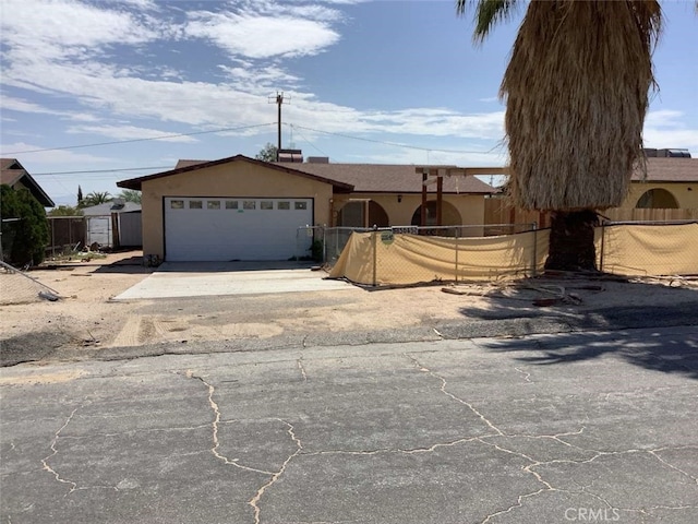 5645 Cahuilla Ave Unit 29, Palms, CA 92277 - single story home featuring driveway, a garage, and stucco siding