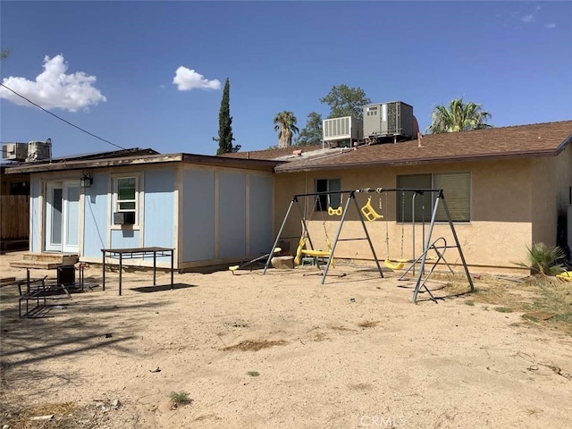 rear view of house with central AC