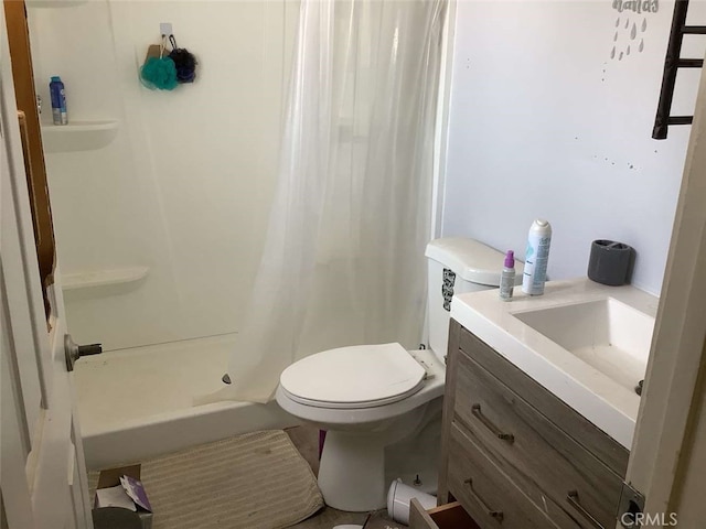 bathroom featuring toilet, vanity, and curtained shower