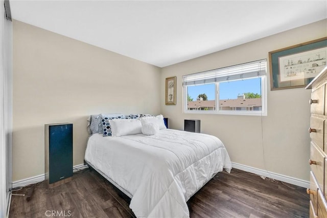 bedroom with dark hardwood / wood-style flooring