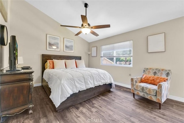 bedroom with ceiling fan, dark hardwood / wood-style flooring, and vaulted ceiling