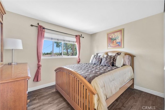 bedroom with dark hardwood / wood-style flooring