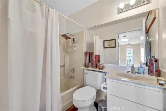 full bathroom with shower / tub combo with curtain, vanity, and toilet