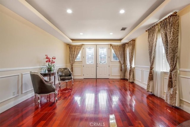 foyer featuring hardwood / wood-style flooring and a tray ceiling