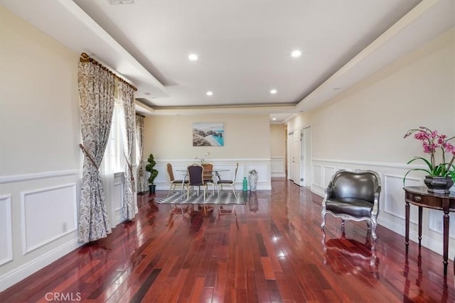 interior space featuring hardwood / wood-style flooring and a raised ceiling